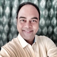 Ranjan-Kumar-min a man smiling for the camera