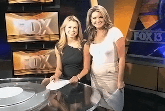 two women holding a drum set
