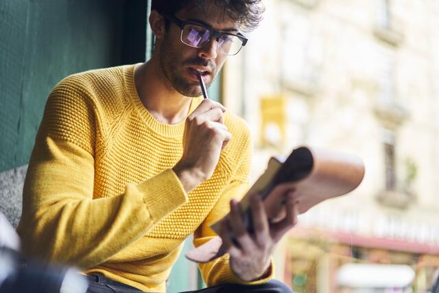 Create your Lead Magnet (or free gift) a man in glasses holding a phone